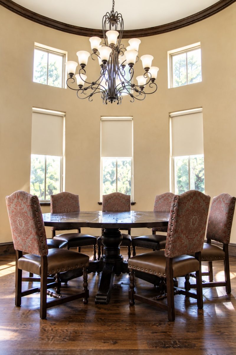 Round conference table under a chandelier in the office's meeting room
