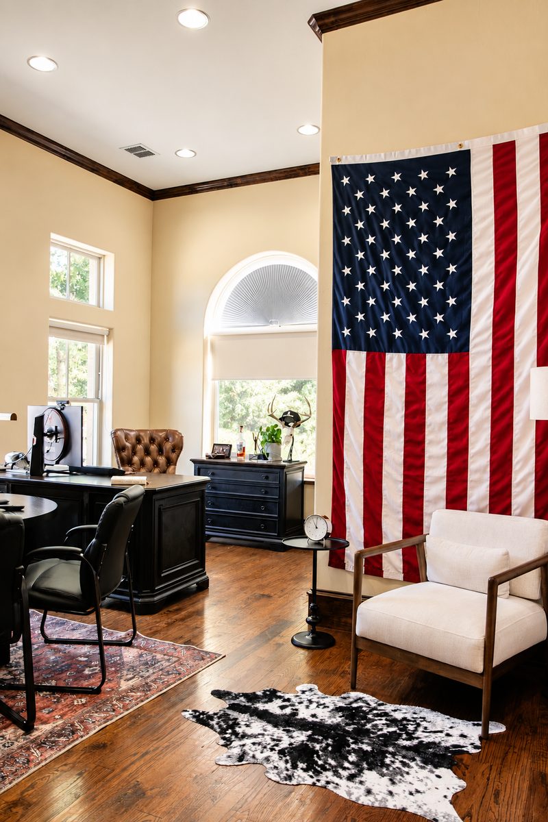 Office workspace with an American flag on the wall