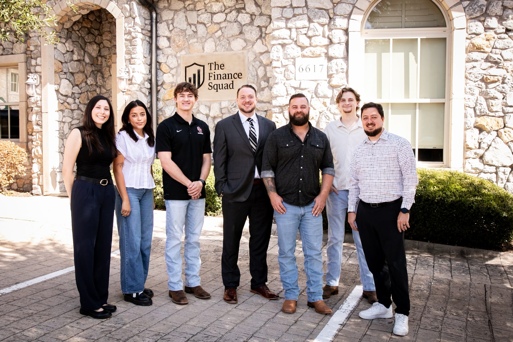 The Finance Squad team standing together outside the McKinney office