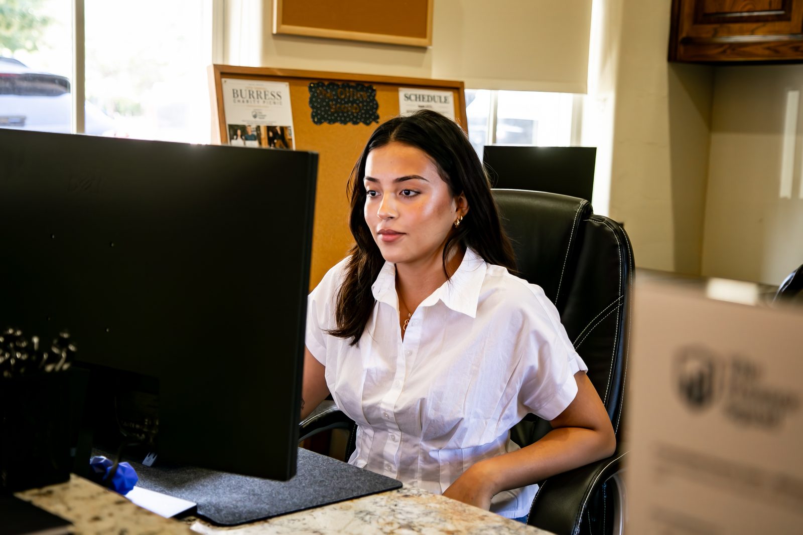 A team member working at the front desk