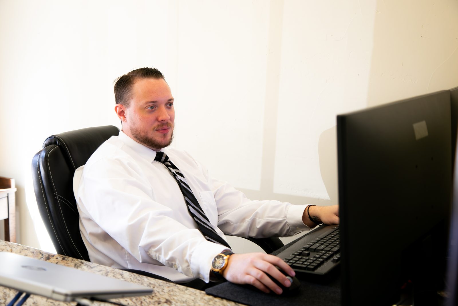 A team member working through the morning's queue at his desk